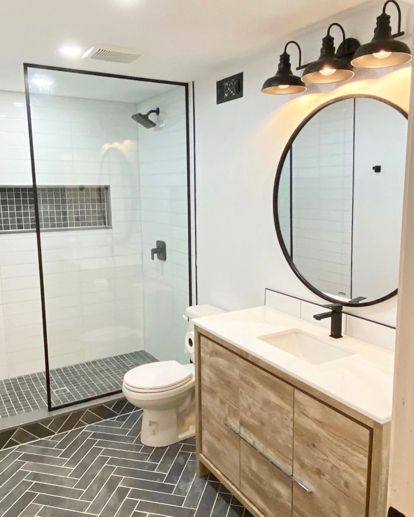 Completed modern bathroom with glass shower and custom vanity