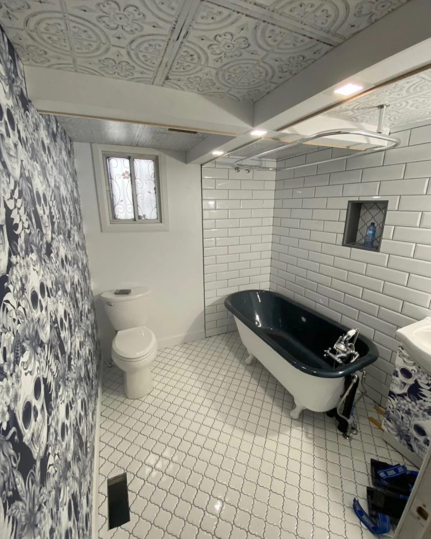 Bathroom with clawfoot tub and patterned wall