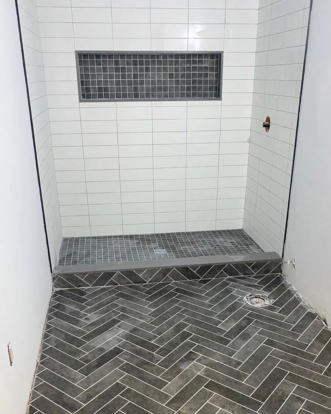 Herringbone shower floor and linear accent