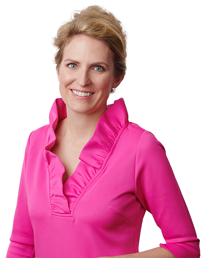 Blonde caucasian woman with a big smile showing teeth wearing a blue shirt with arms folded