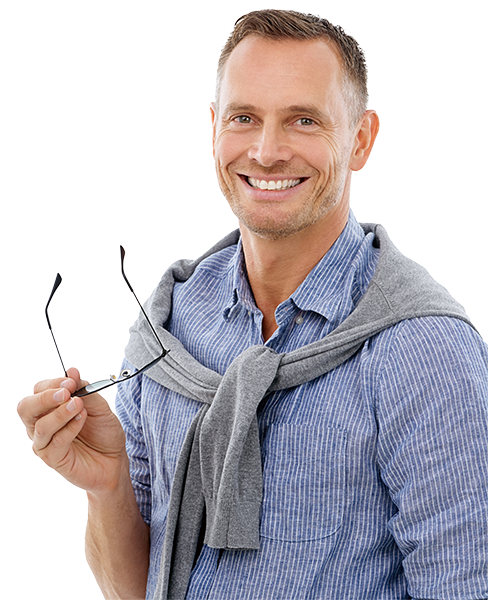 Smiling caucasian man holding his glasses wearing blue striped shirt and grey sweater around his neck