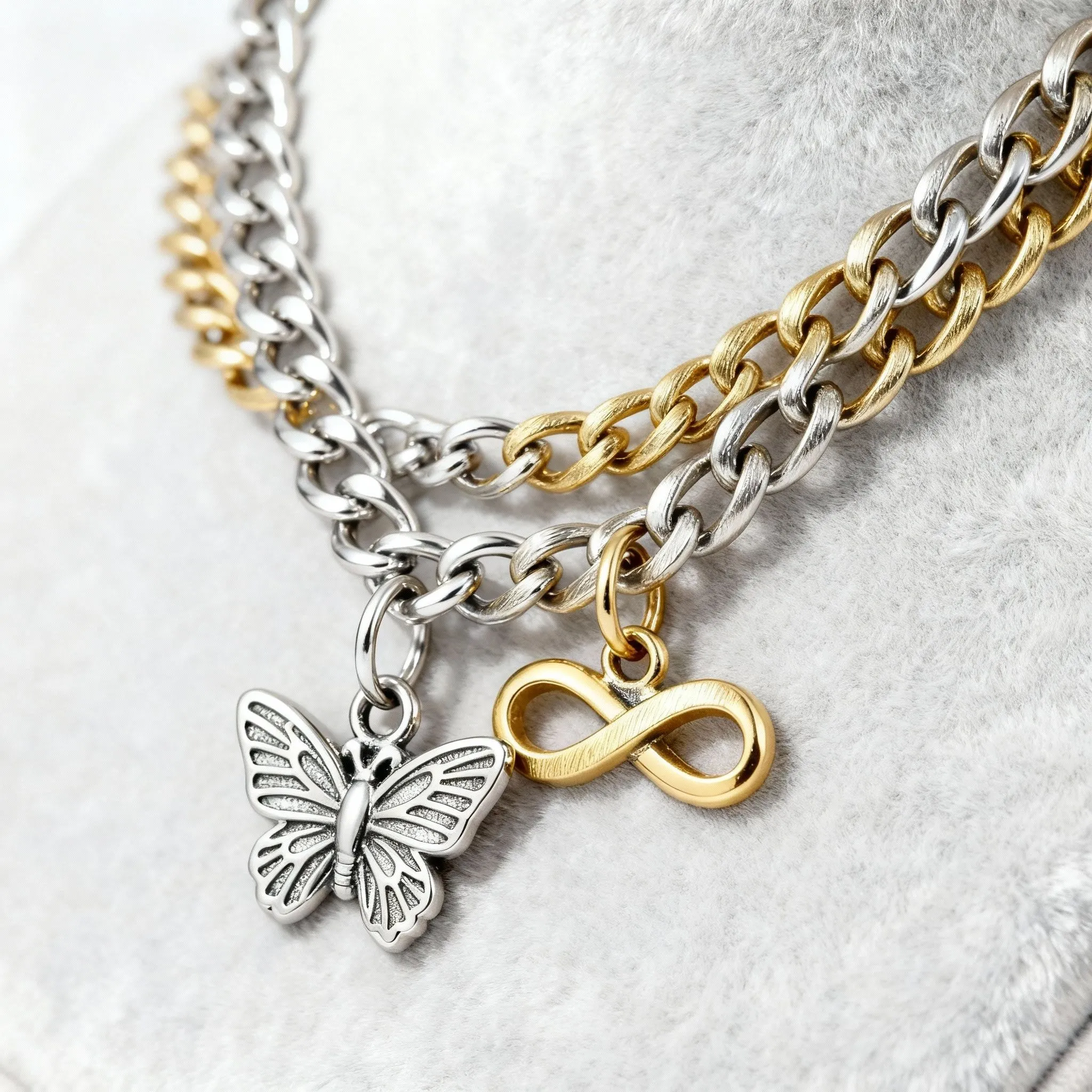 Two tone curb chain with silver butterfly and gold infinity charm permanent jewelry