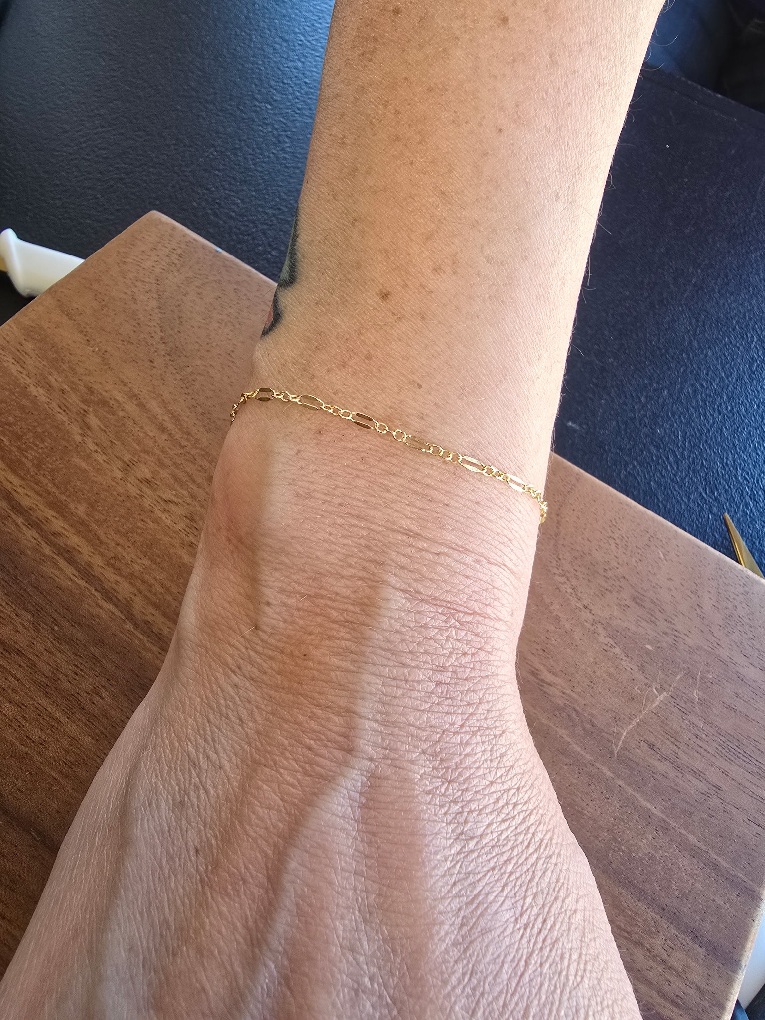 Gold permanent bracelet welded on a client's wrist, Arizona