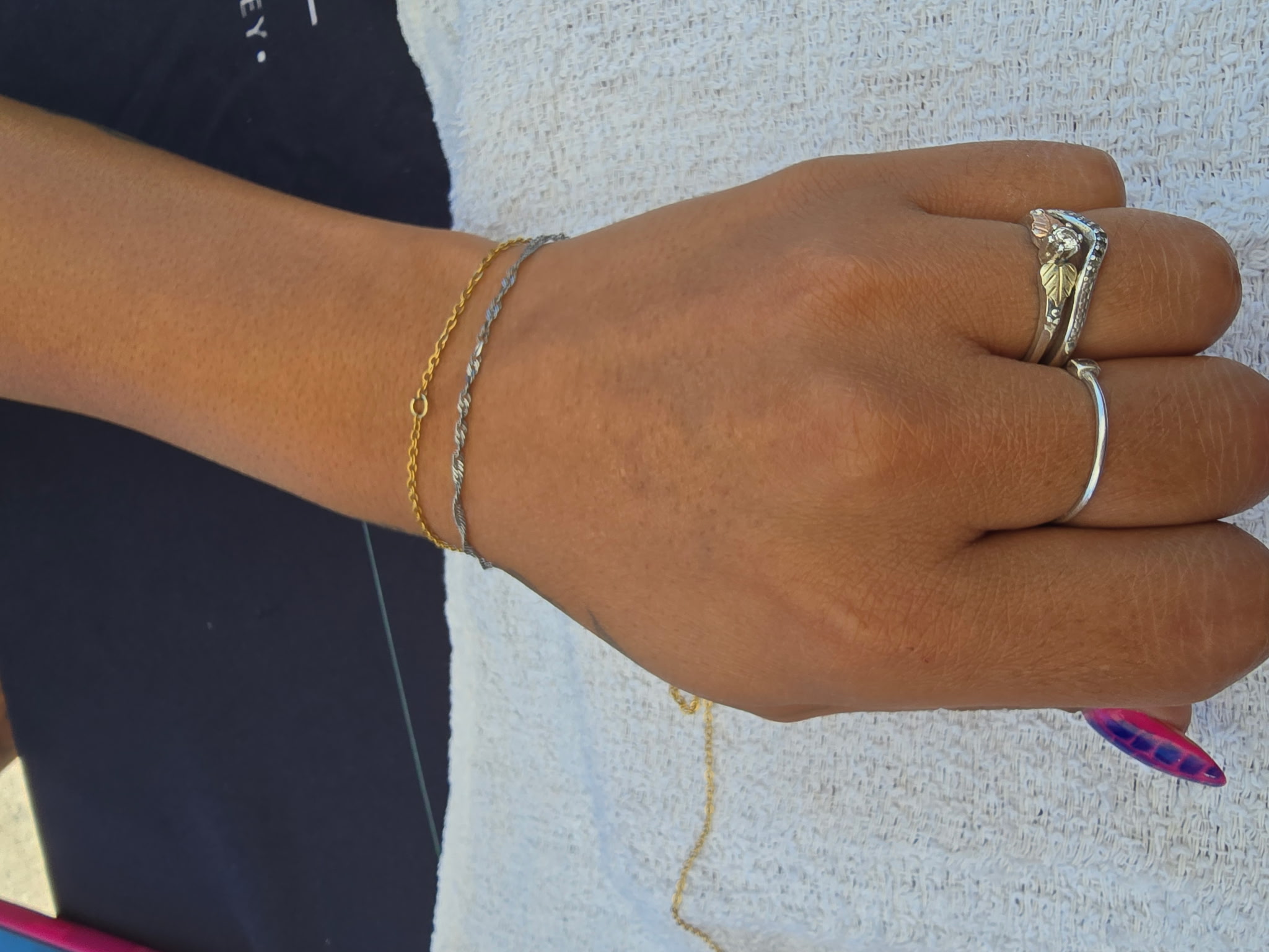 Stacked permanent bracelets gold and silver on wrist Eternally Linked Bling