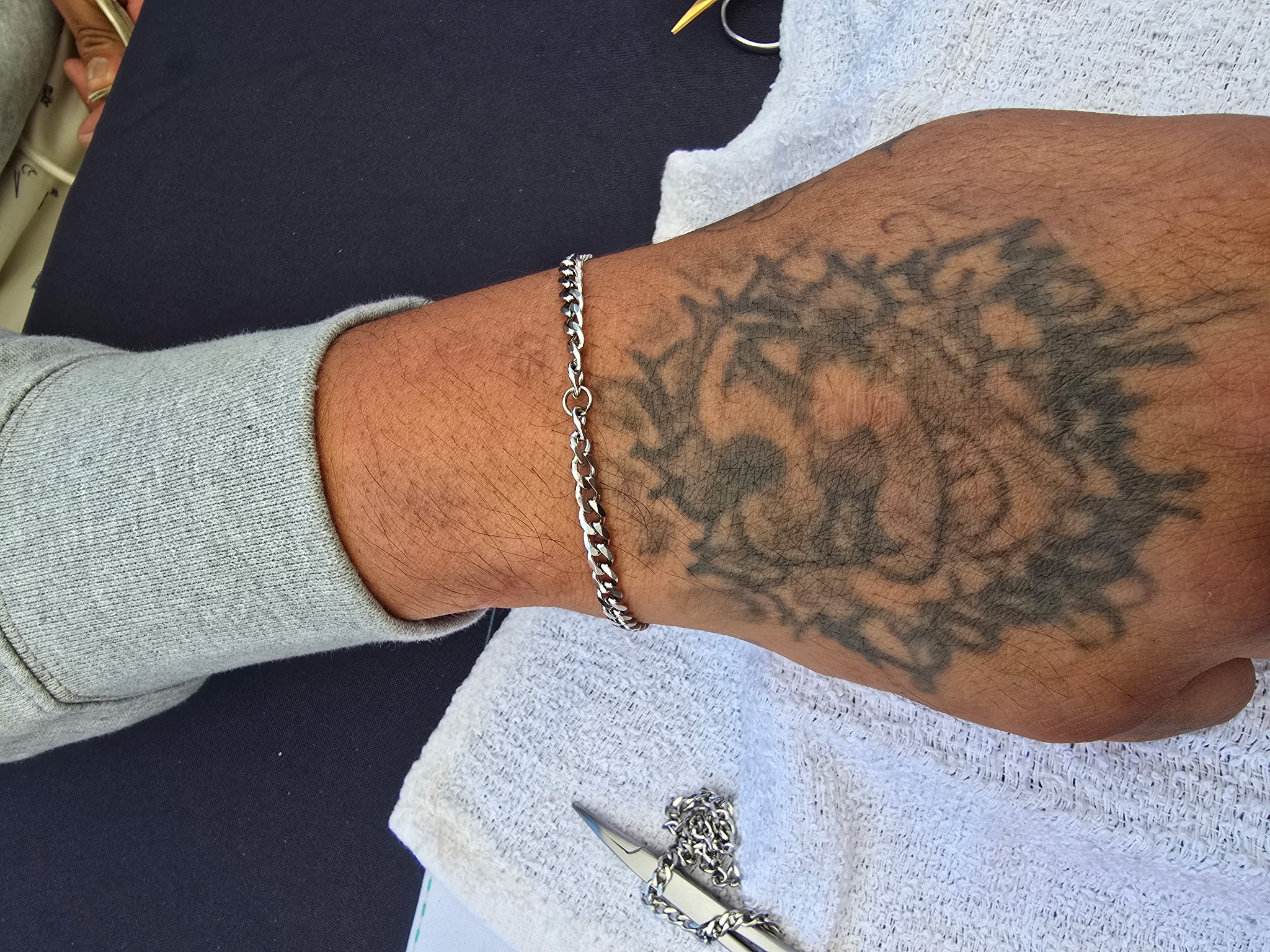Tattooed wrist with permanent bracelet Eternally Linked Bling