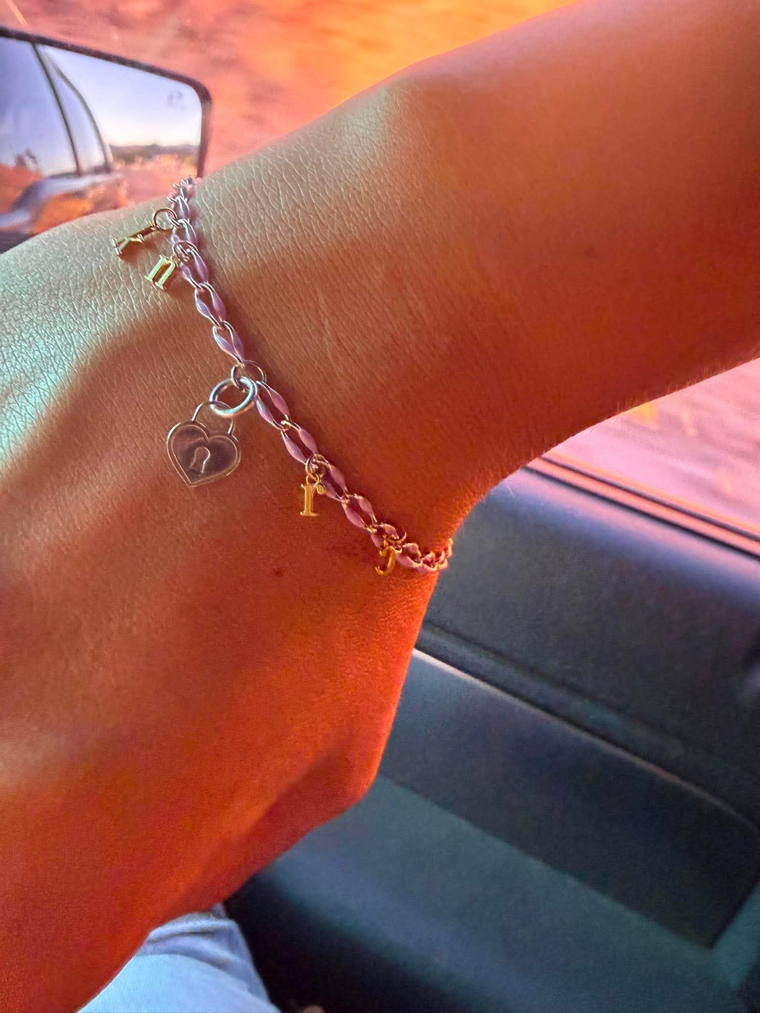 Charm bracelet welded on a wrist, worn on the drive home from a permanent jewelry fitting near Gisela AZ