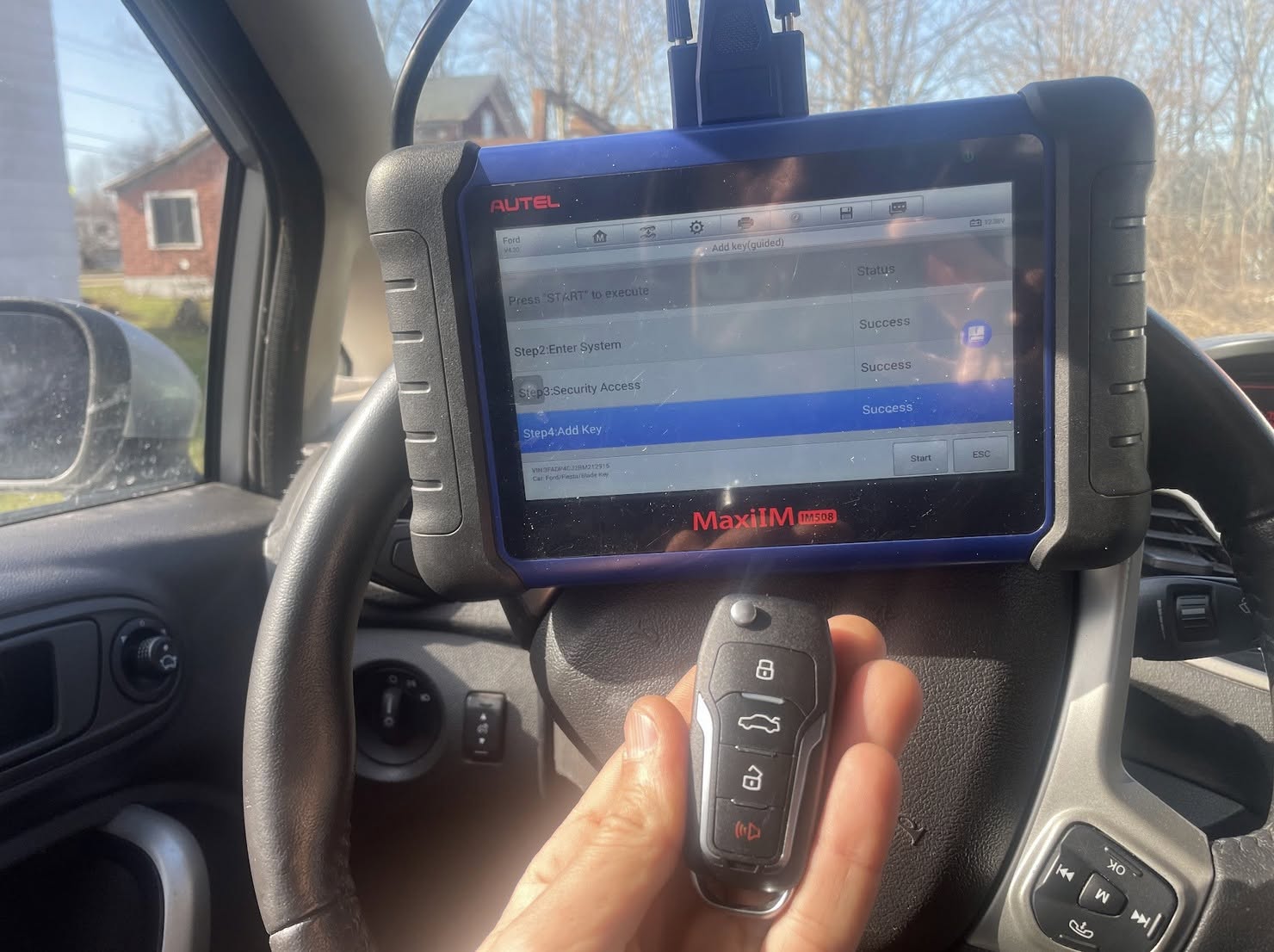 Technician using a key cutting machine during a mobile service call