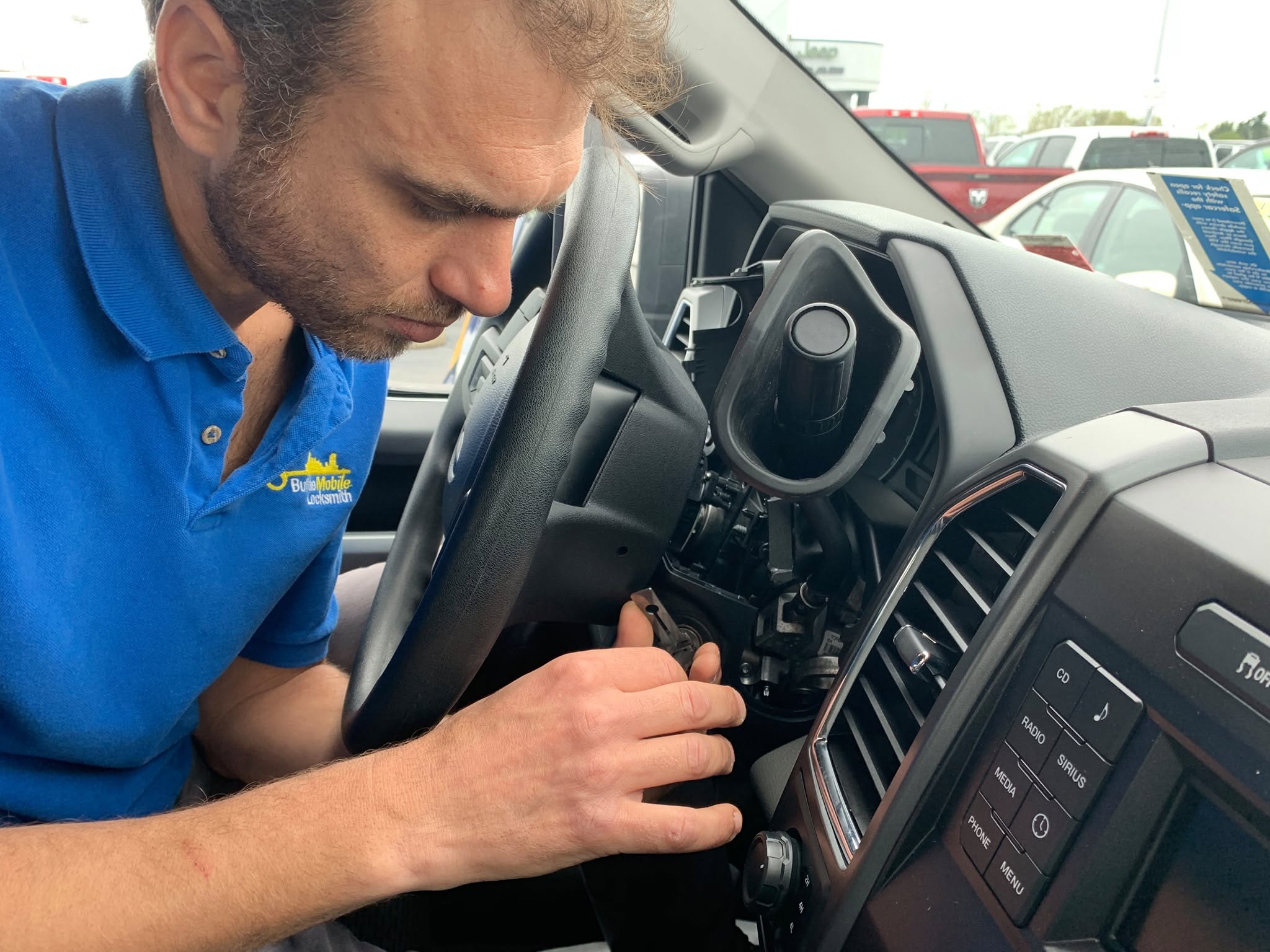 Technician extracting a broken key from a car door