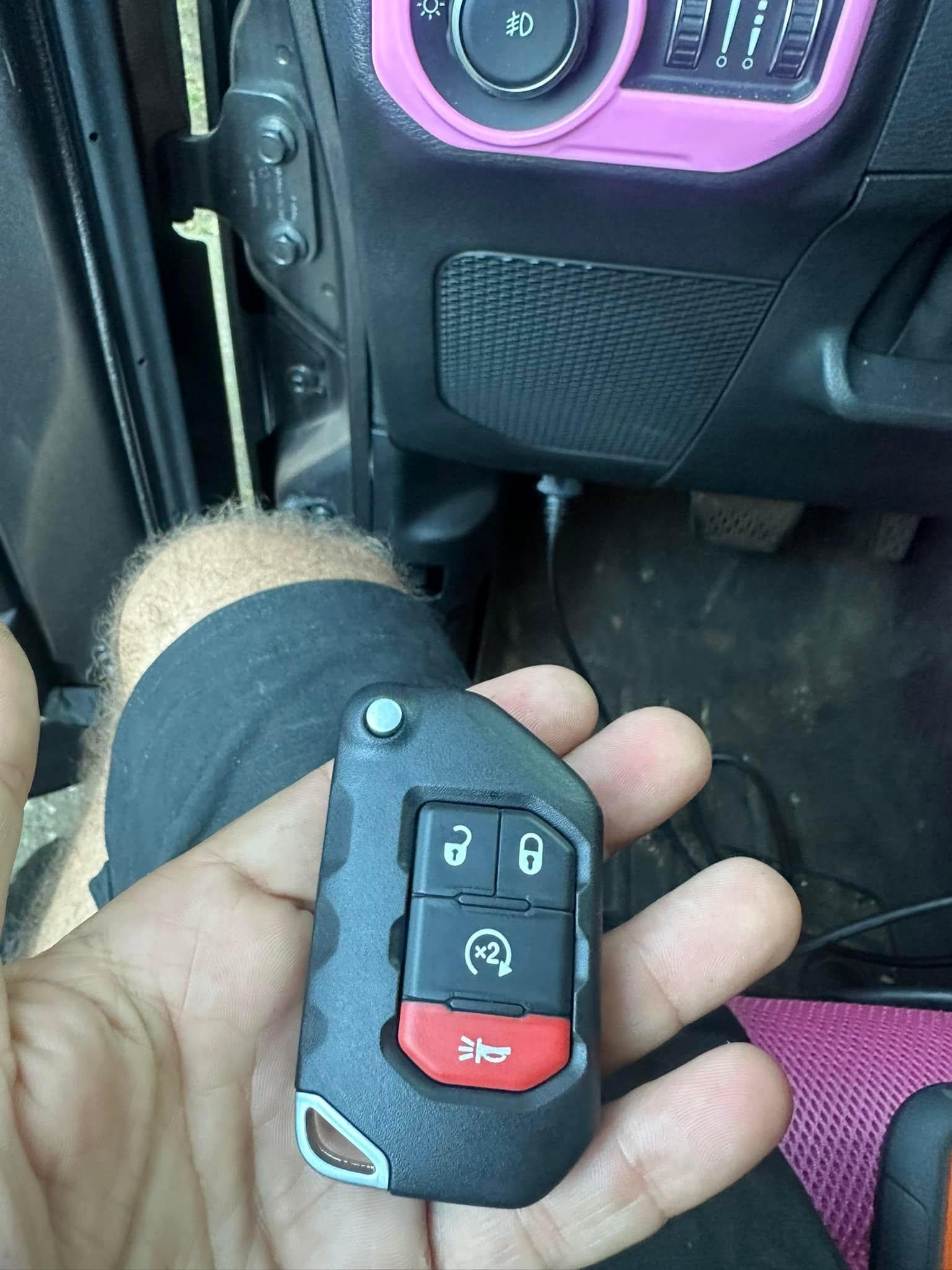 Close-up of a car key fob being reprogrammed on site