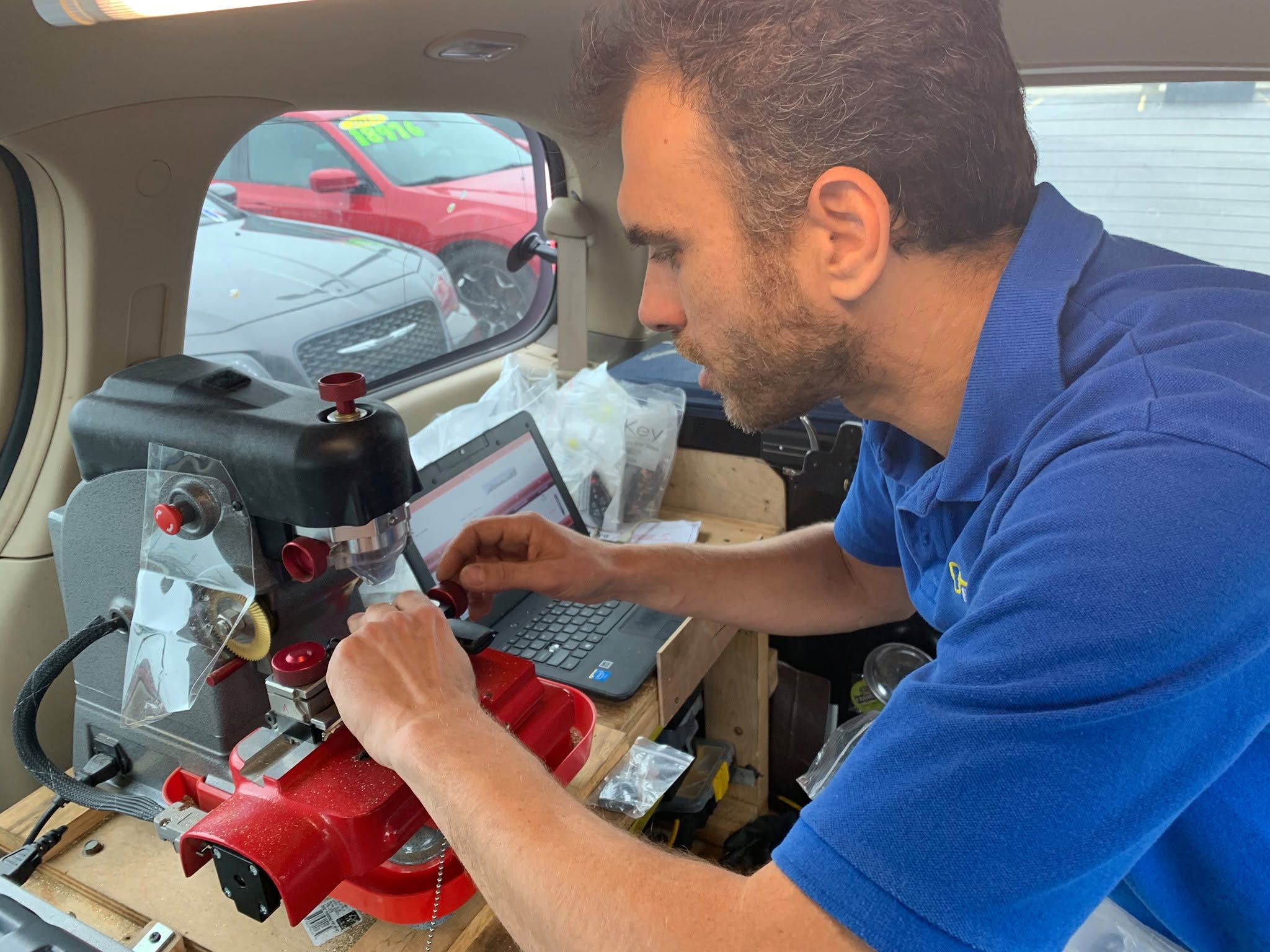 New car key being tested in the ignition after on-site cutting