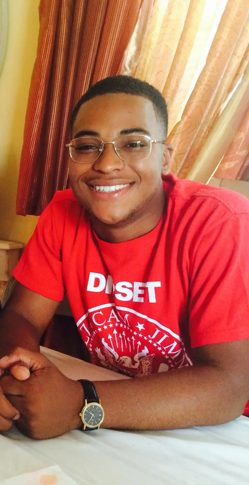 Will smiling in a red shirt
