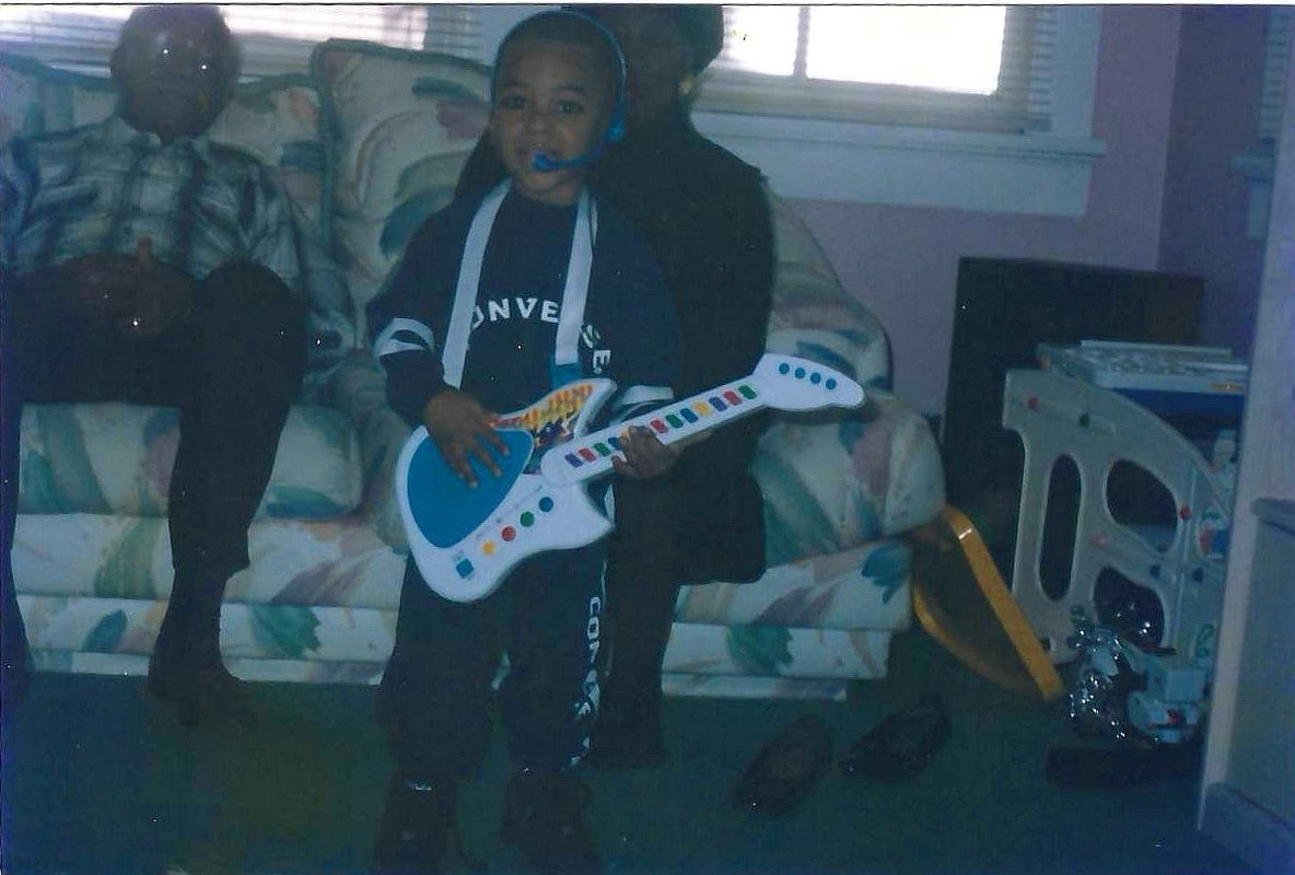 Young Will holding a toy guitar