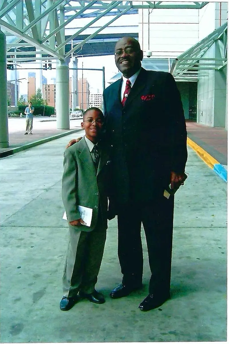 Young Will standing with a pastor
