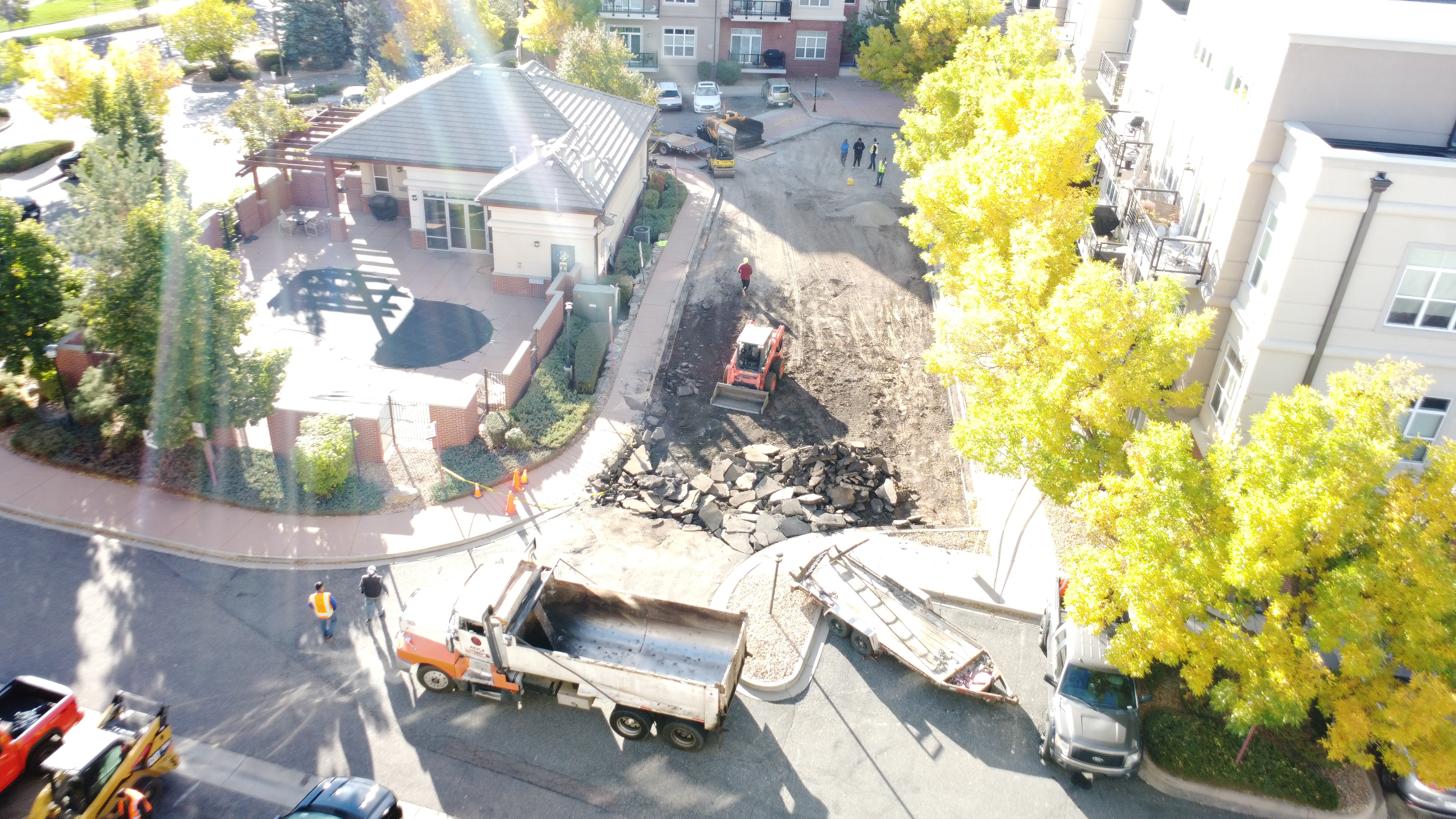 Skid steer clearing asphalt debris