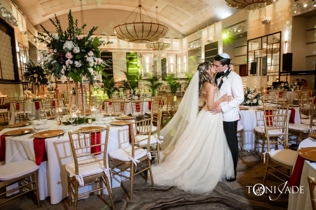 Candlelit ballroom reception with low and high floral arrangements