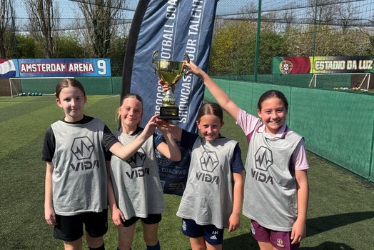 Three camp winners holding up their prizes
