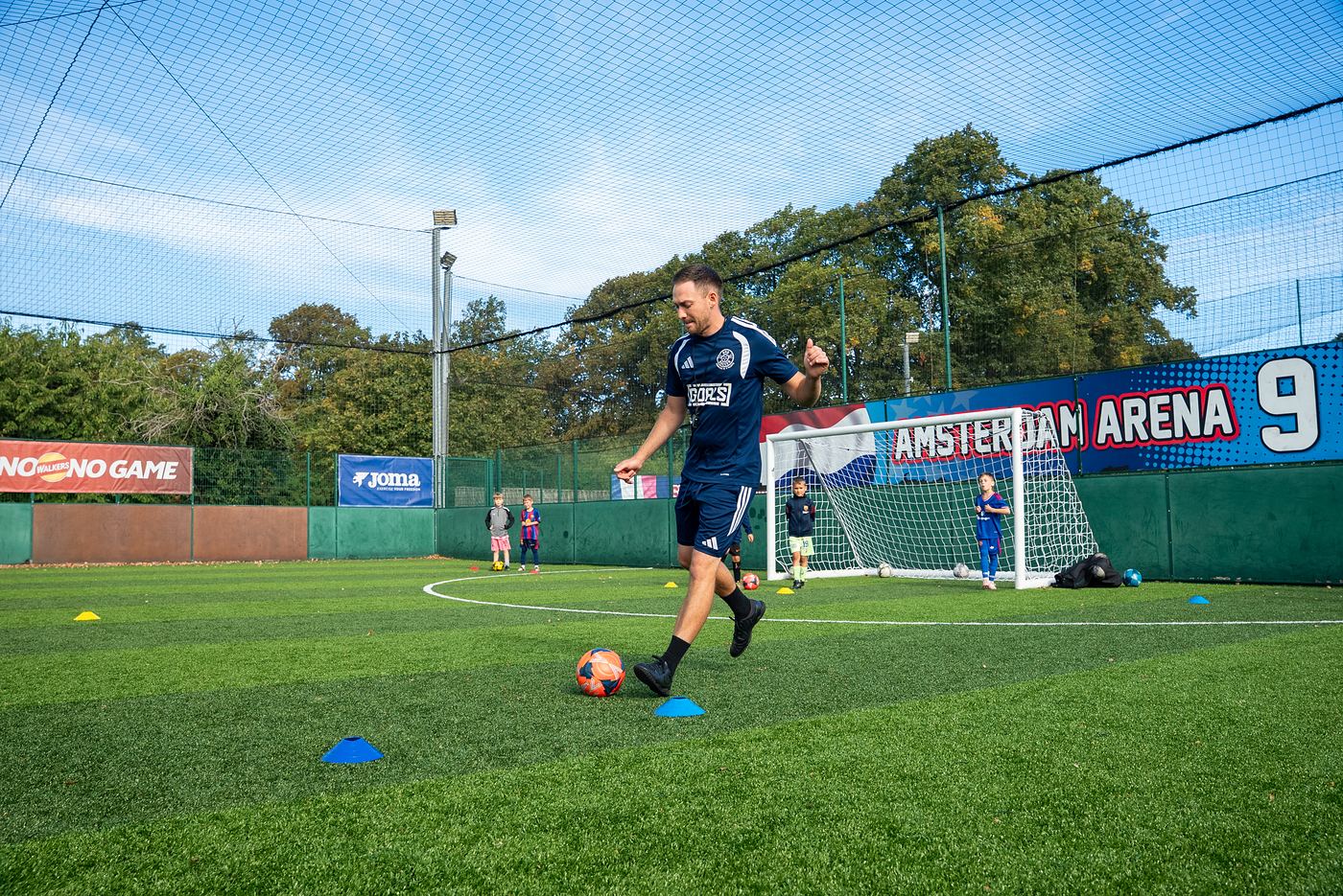 A ShoSoccer coach running a ball skills drill