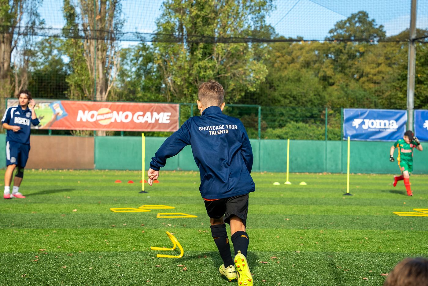 A player on the ball with a ShoSoccer coach