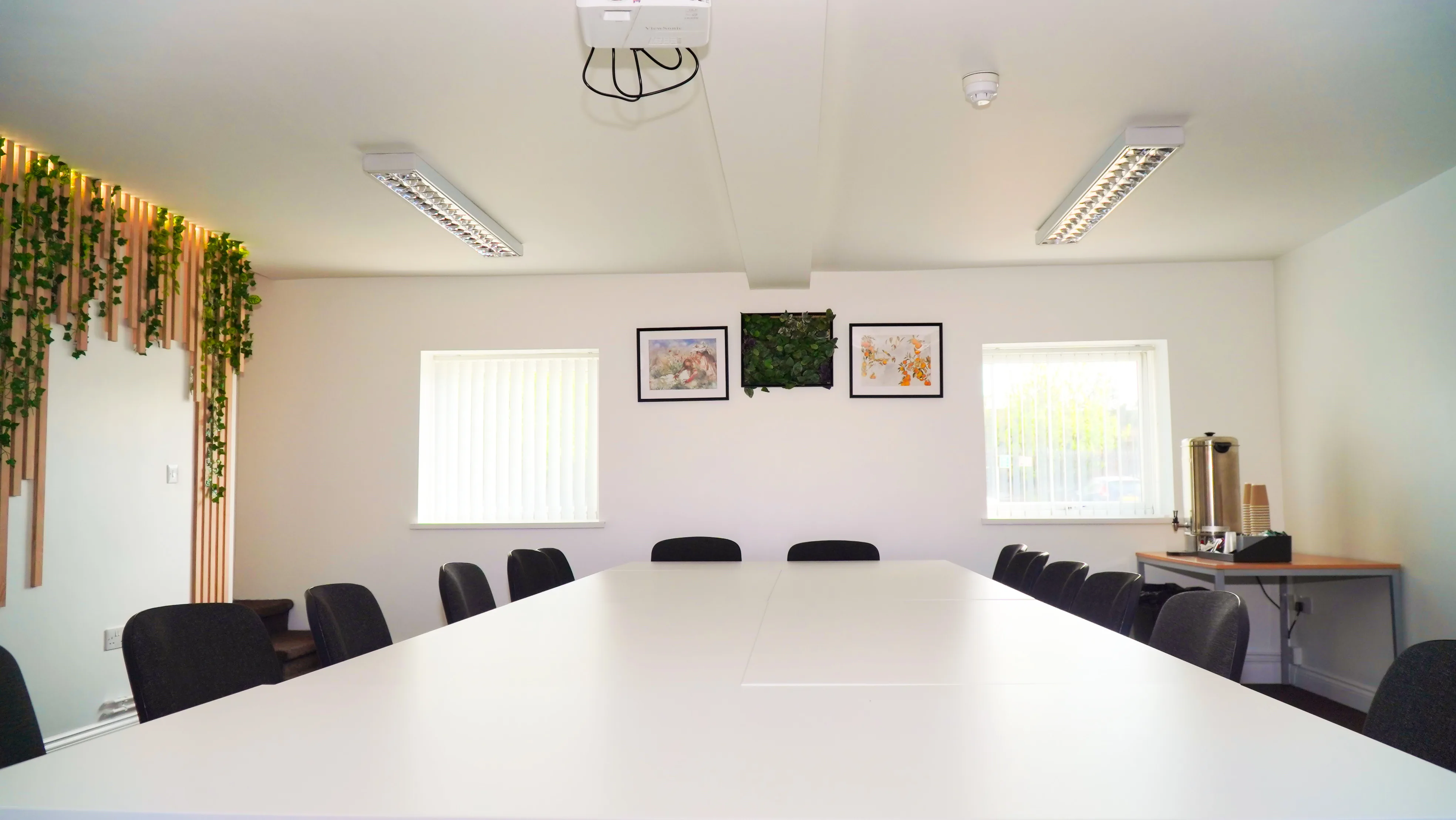 The Forum meeting and training room at the Maggie O'Neill Centre, bright with a long white table