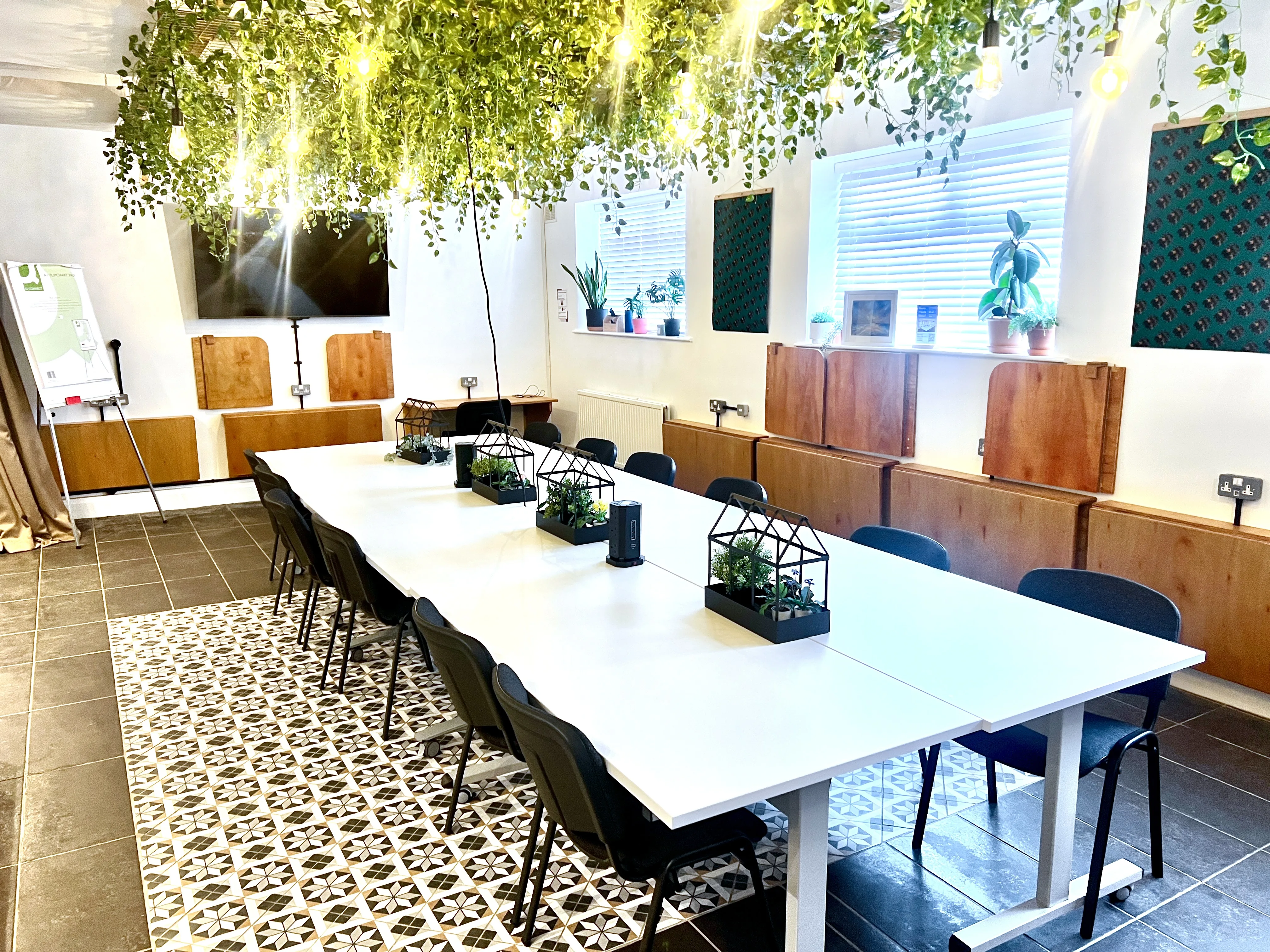 The Grove at the Maggie O'Neill Centre, with a greenery canopy over a long white table
