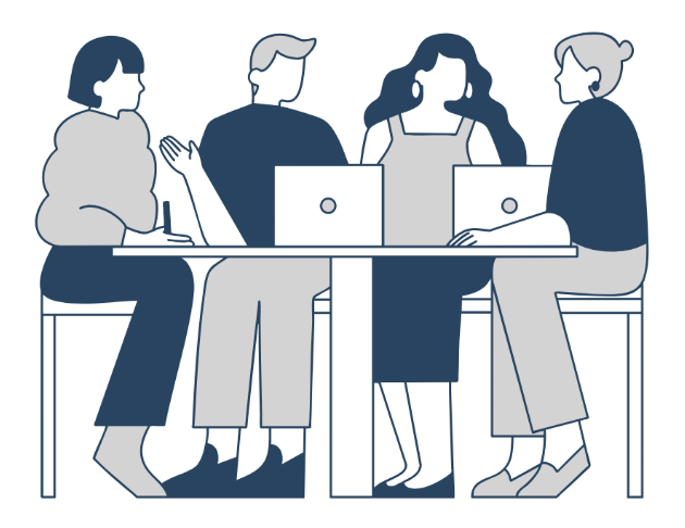 People sitting at a table during a meeting with their computers