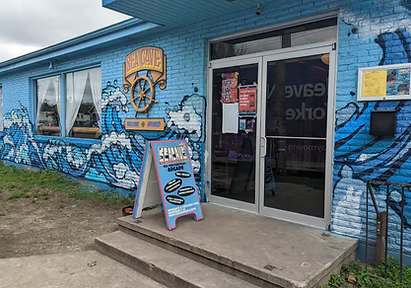 Sea Cave Arcade storefront on St. Claude Ave, with its blue wave mural