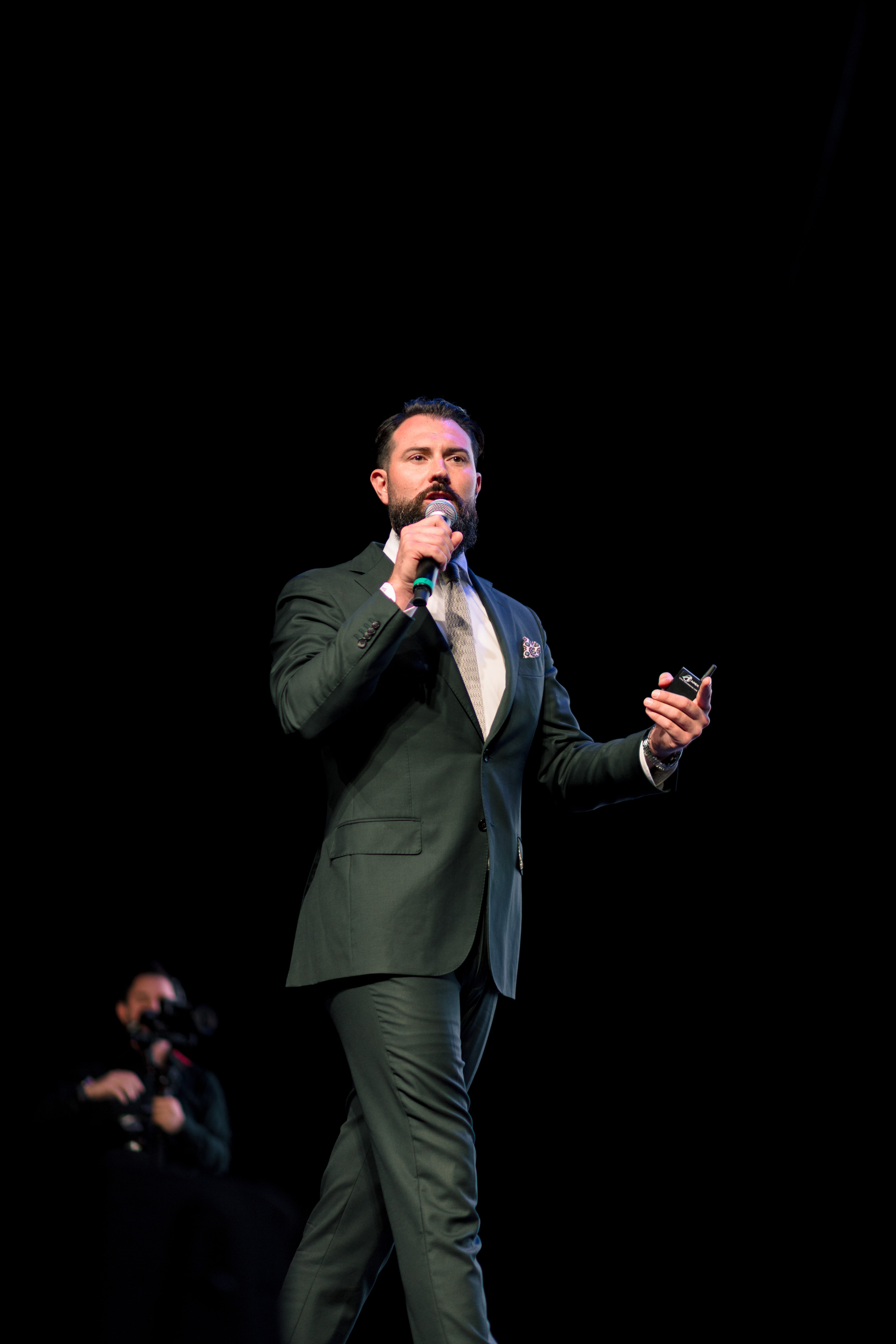 Tyler McLay speaking on stage