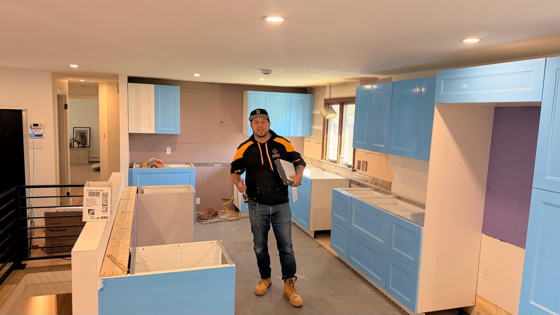 Eder, founder of ECR Marble and Granite, on-site during a kitchen countertop installation