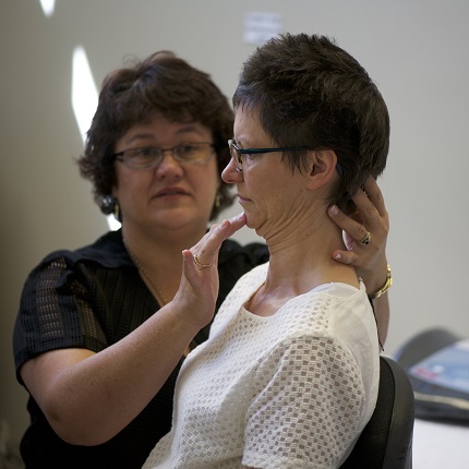 Physiotherapist doing headache assessment