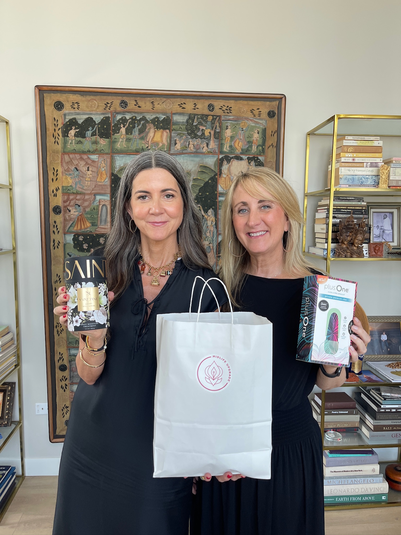 Julie and Pamela holding Midlife Marketplace gifts