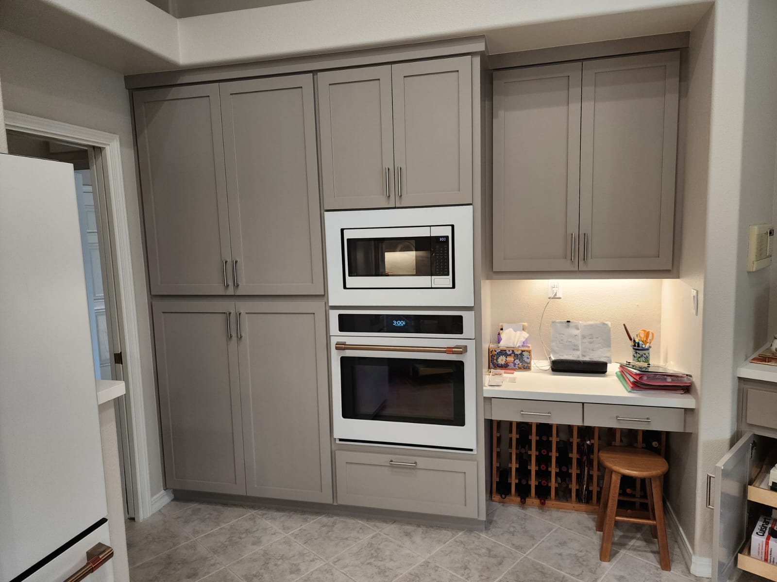 Custom cabinetry surrounding a built-in oven and workspace
