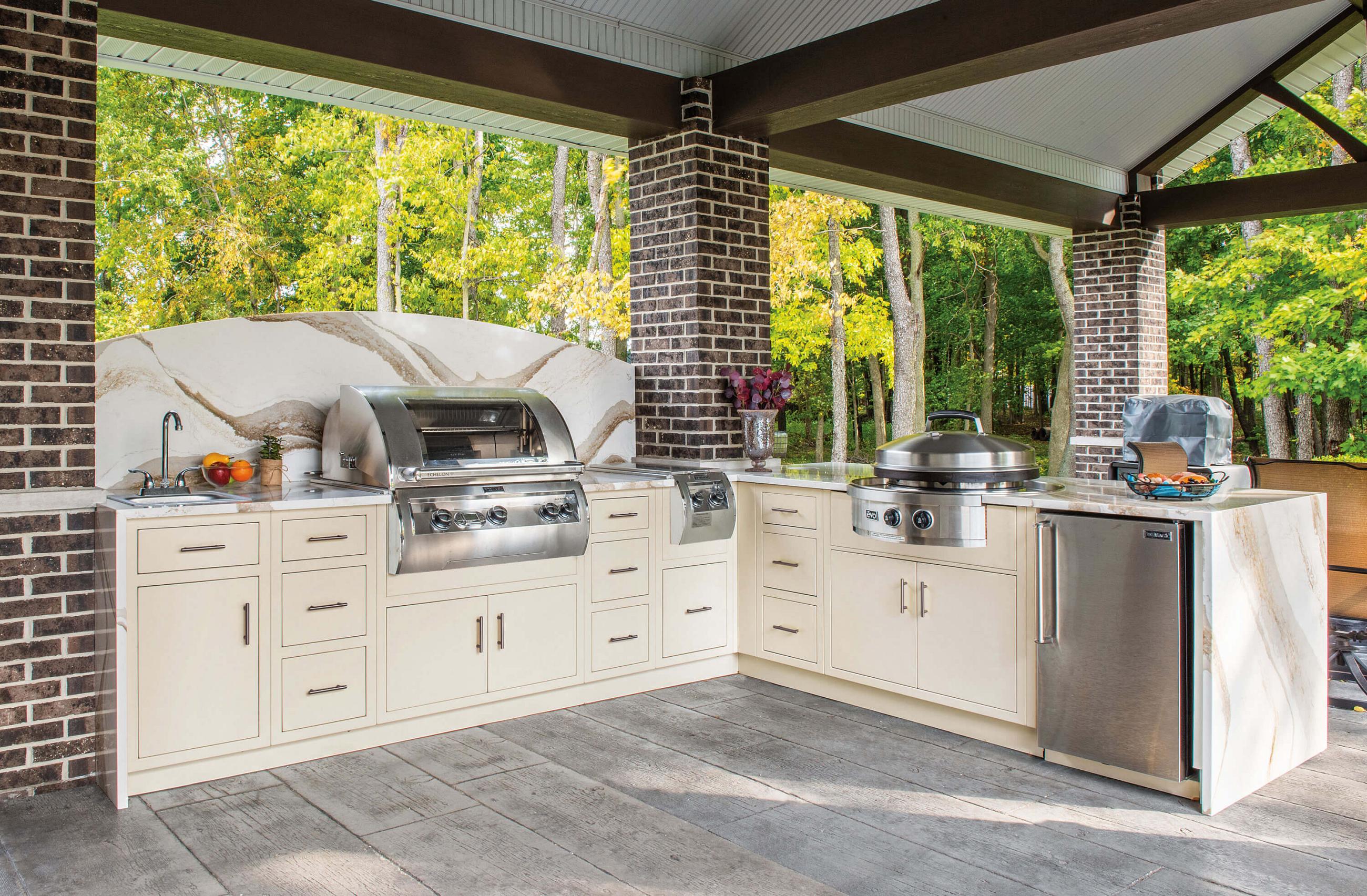 Sandstone aluminum outdoor kitchen cabinets with built-in grill and refrigerator on a covered patio