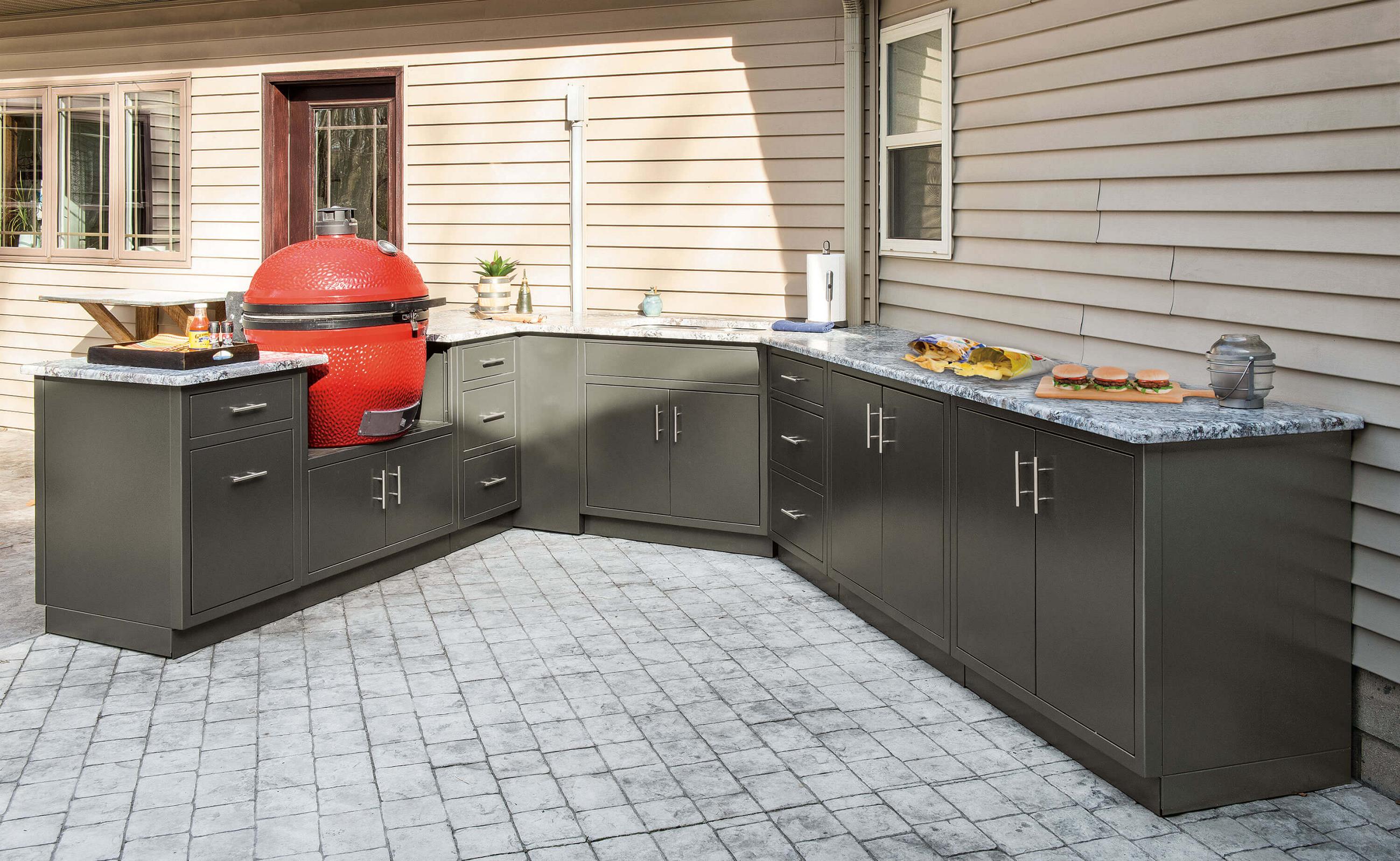 L-shaped black aluminum outdoor cabinets with a ceramic grill set into the countertop