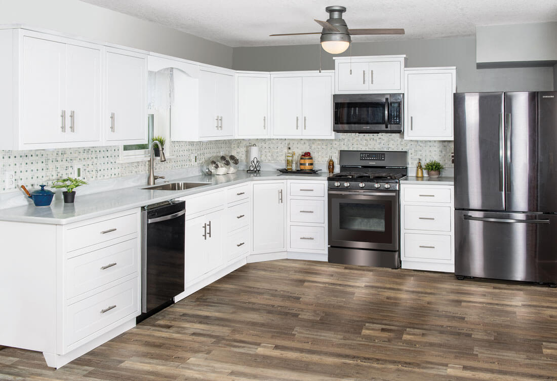 White aluminum kitchen cabinets with soft-close drawers and stainless appliances