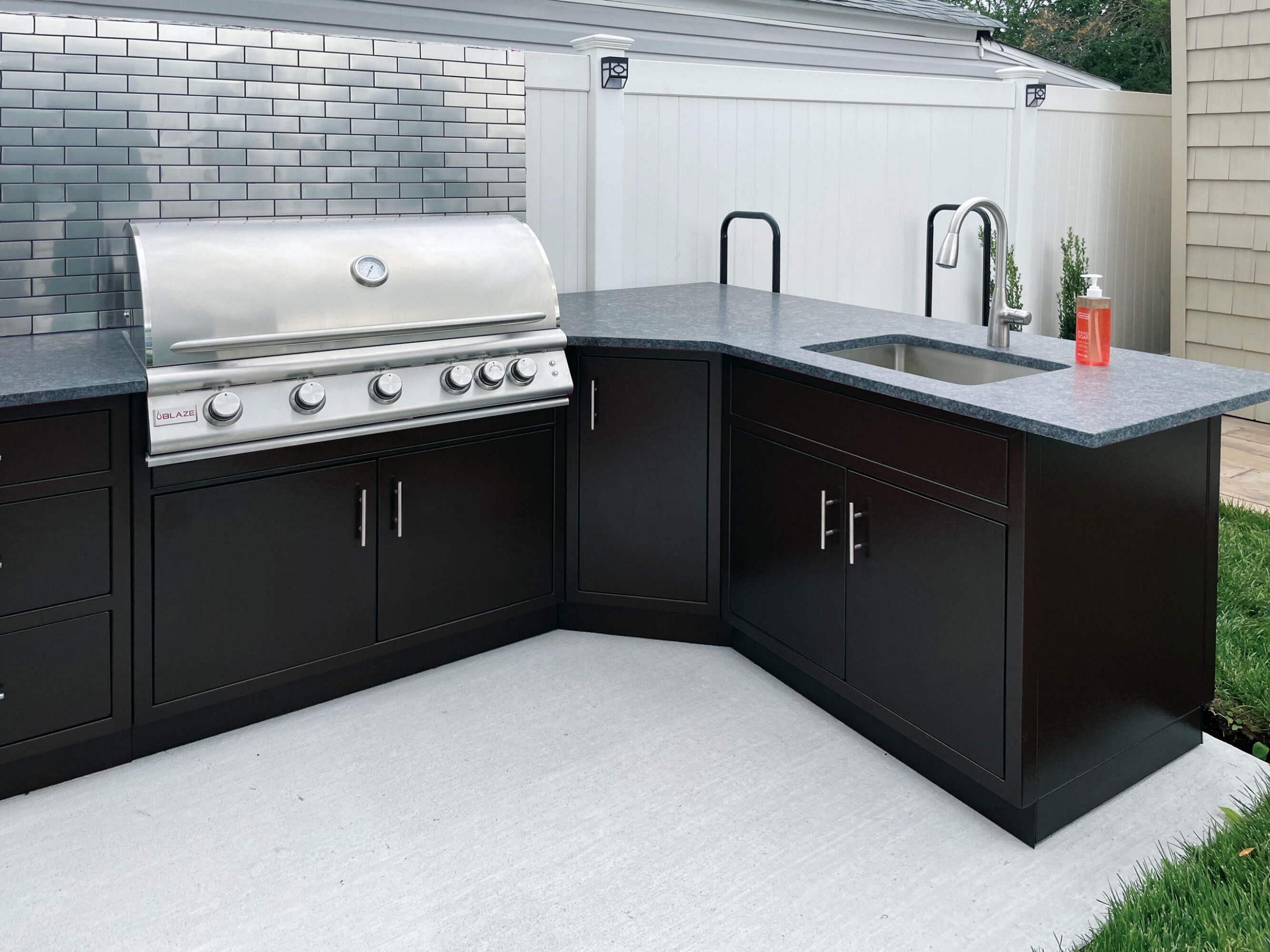 Matte black aluminum outdoor kitchen cabinets with built-in gas grill and sink