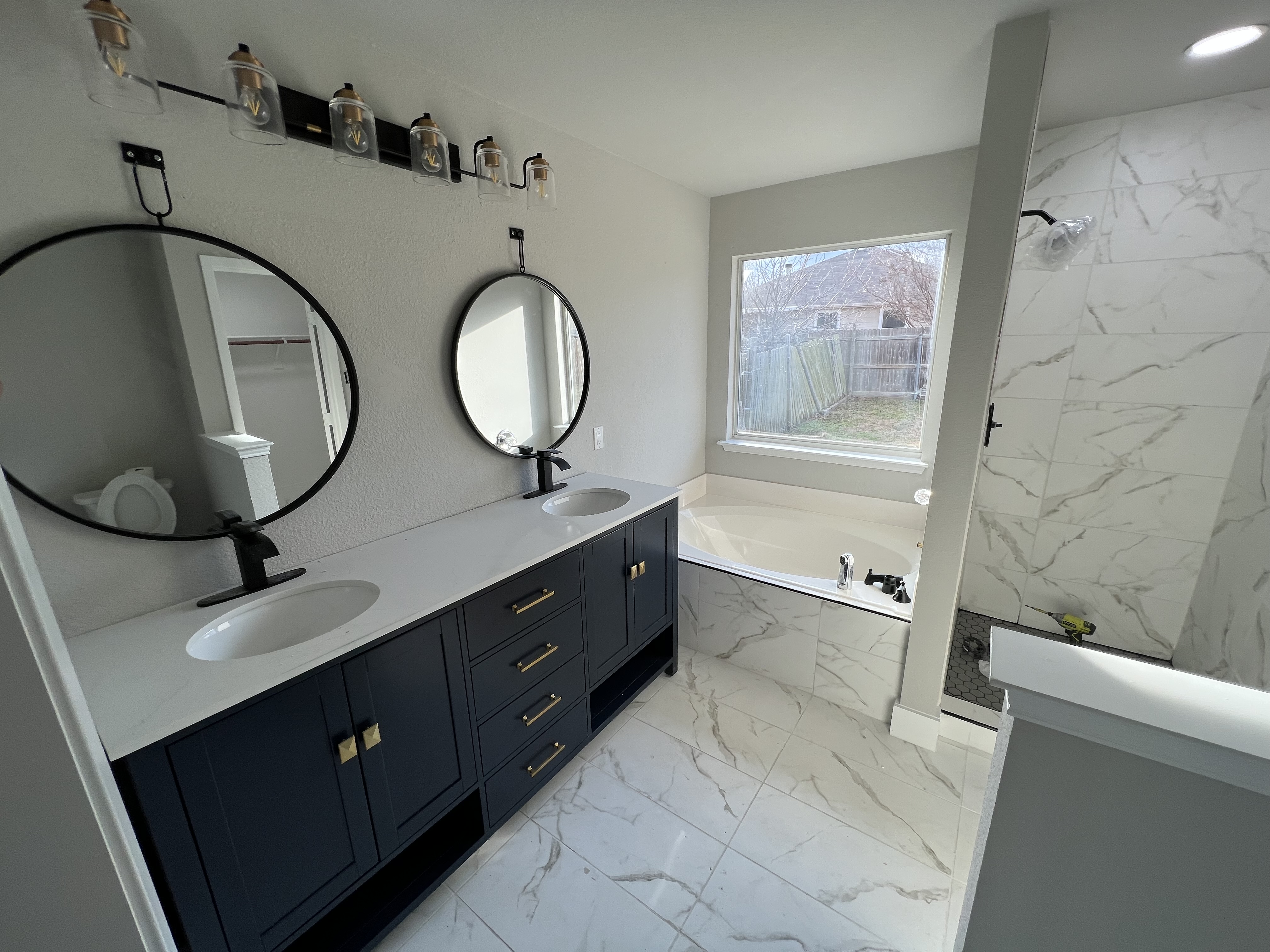 Bathroom makeover features including custom tile, vanity, and walk-in shower by Rockwall Remodeling