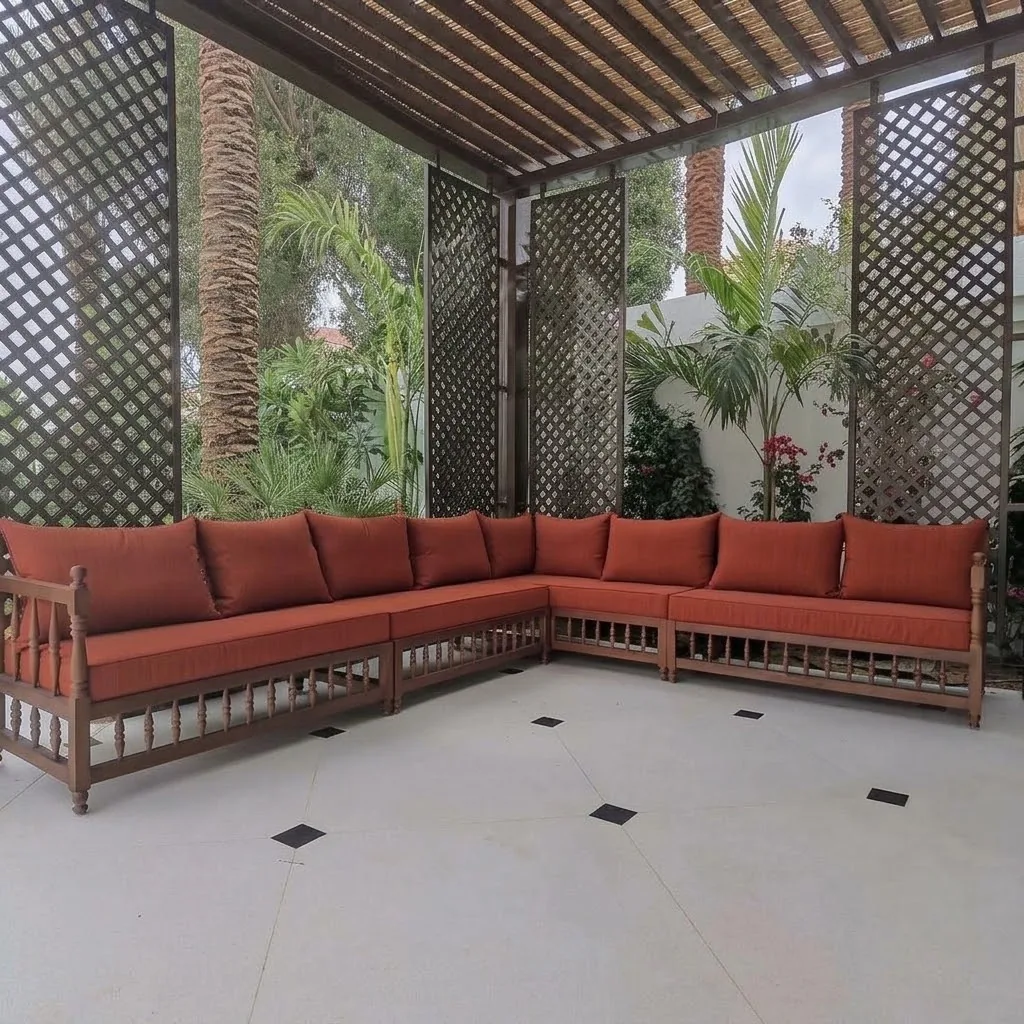 Outdoor sofa with terracotta cushions under a pergola