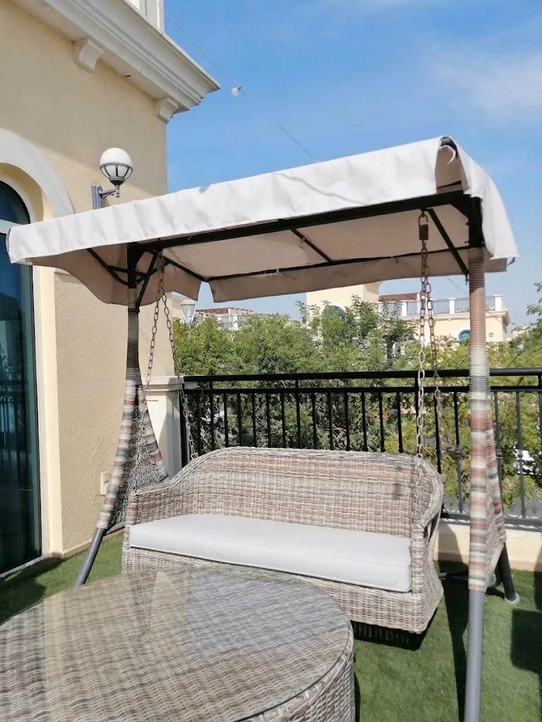 Canopy swing seat with cushions on a balcony