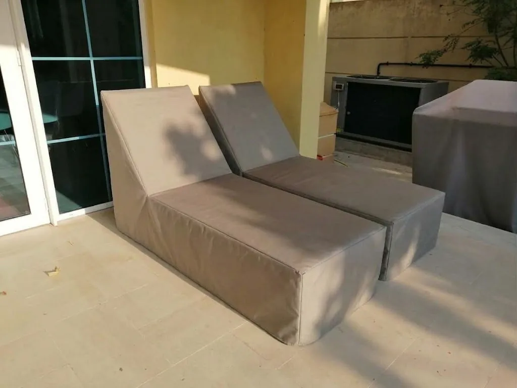 Taupe protective covers on outdoor sunbeds