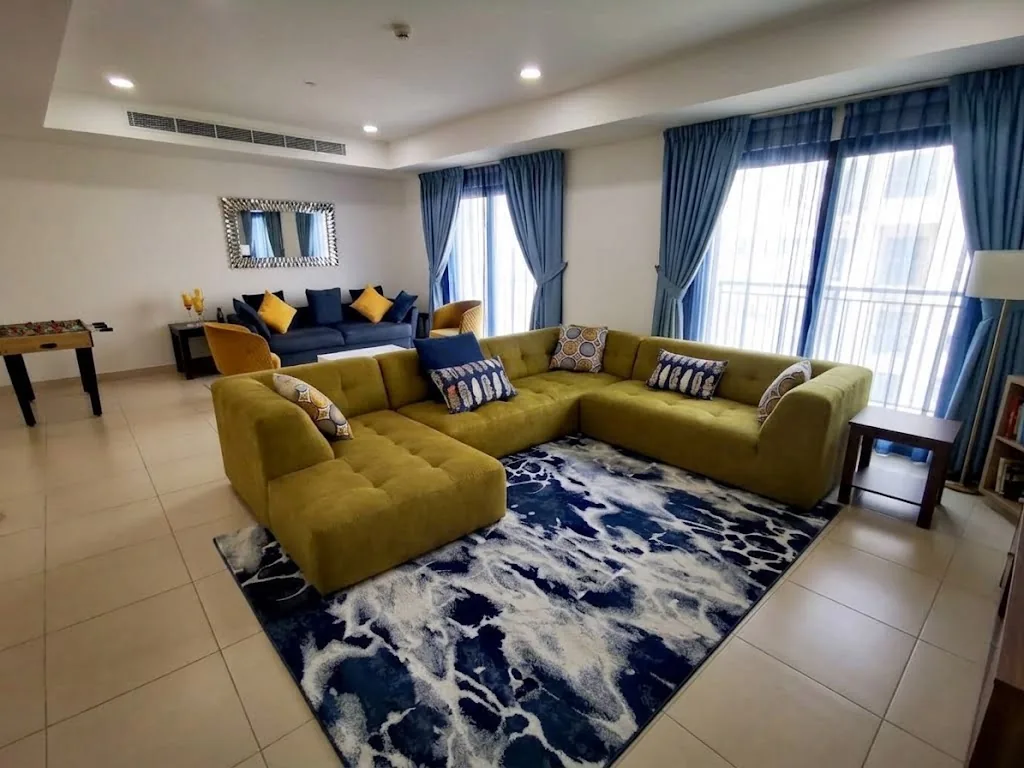 Olive velvet sectional sofa in a family living room