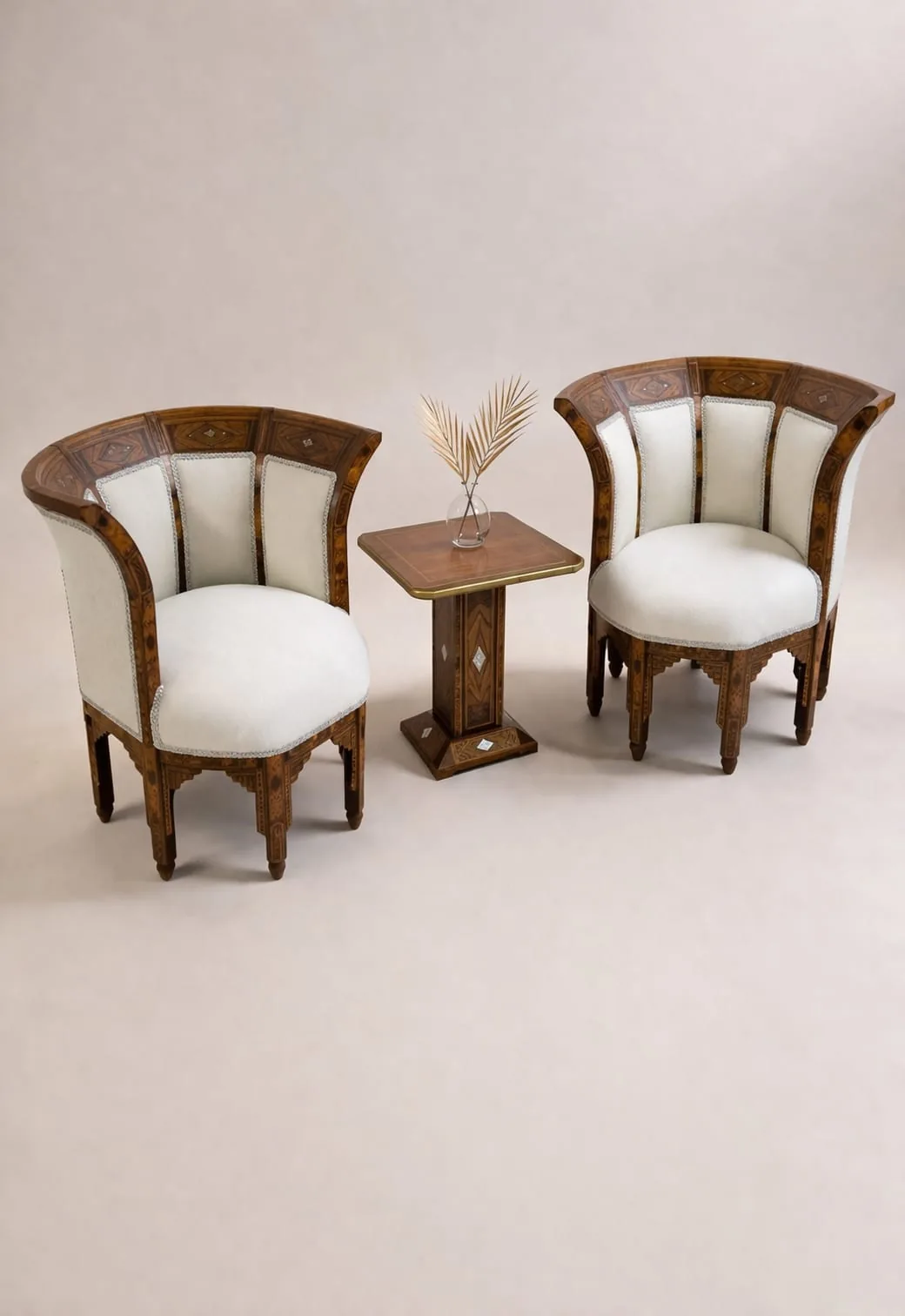 Pair of carved wooden armchairs upholstered in cream fabric