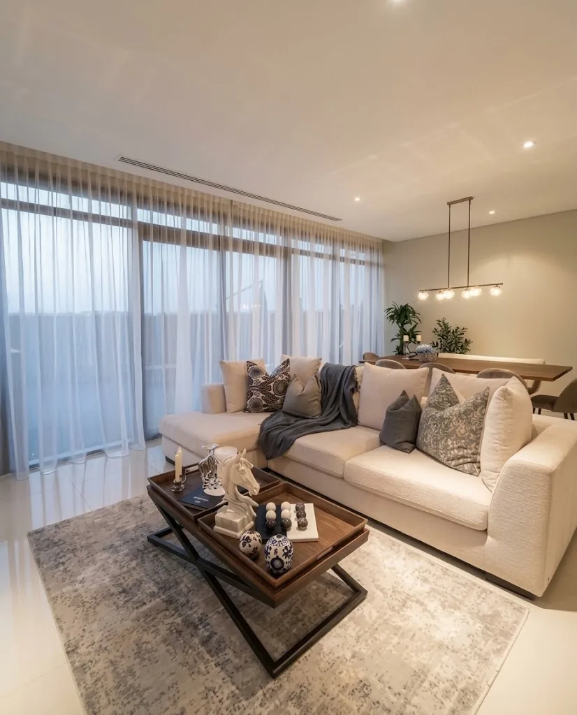 Cream sofa in a living room with sheer curtains