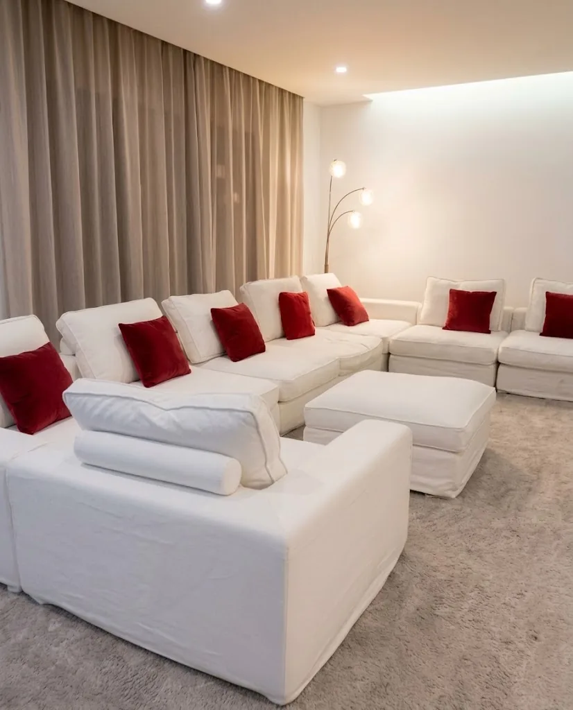 White sectional sofa with red cushions