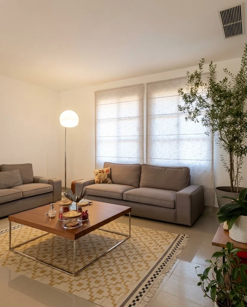 Taupe sofa in a living room with Roman blinds