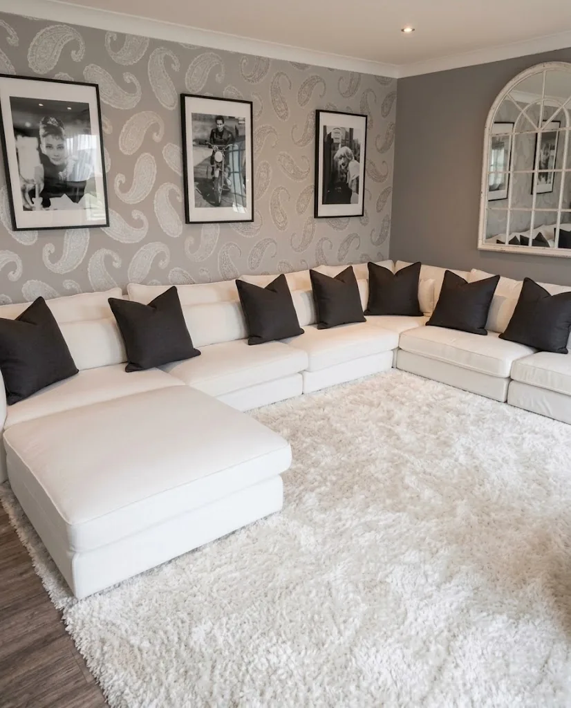 White L-shaped sofa with black cushions