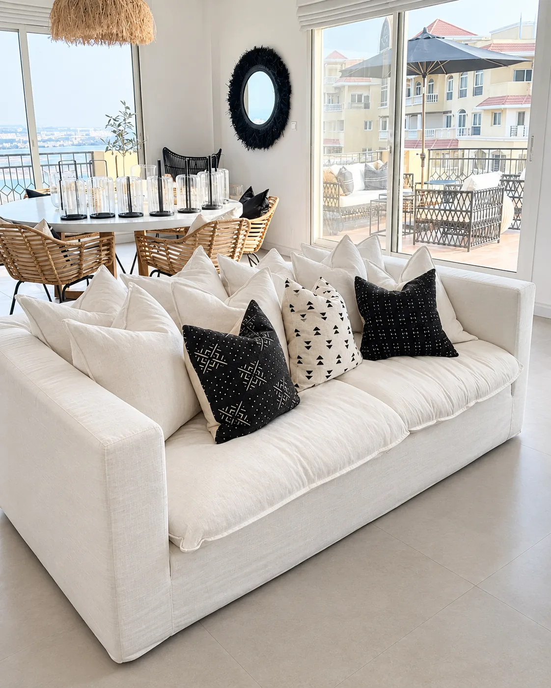 White linen sofa with black patterned cushions