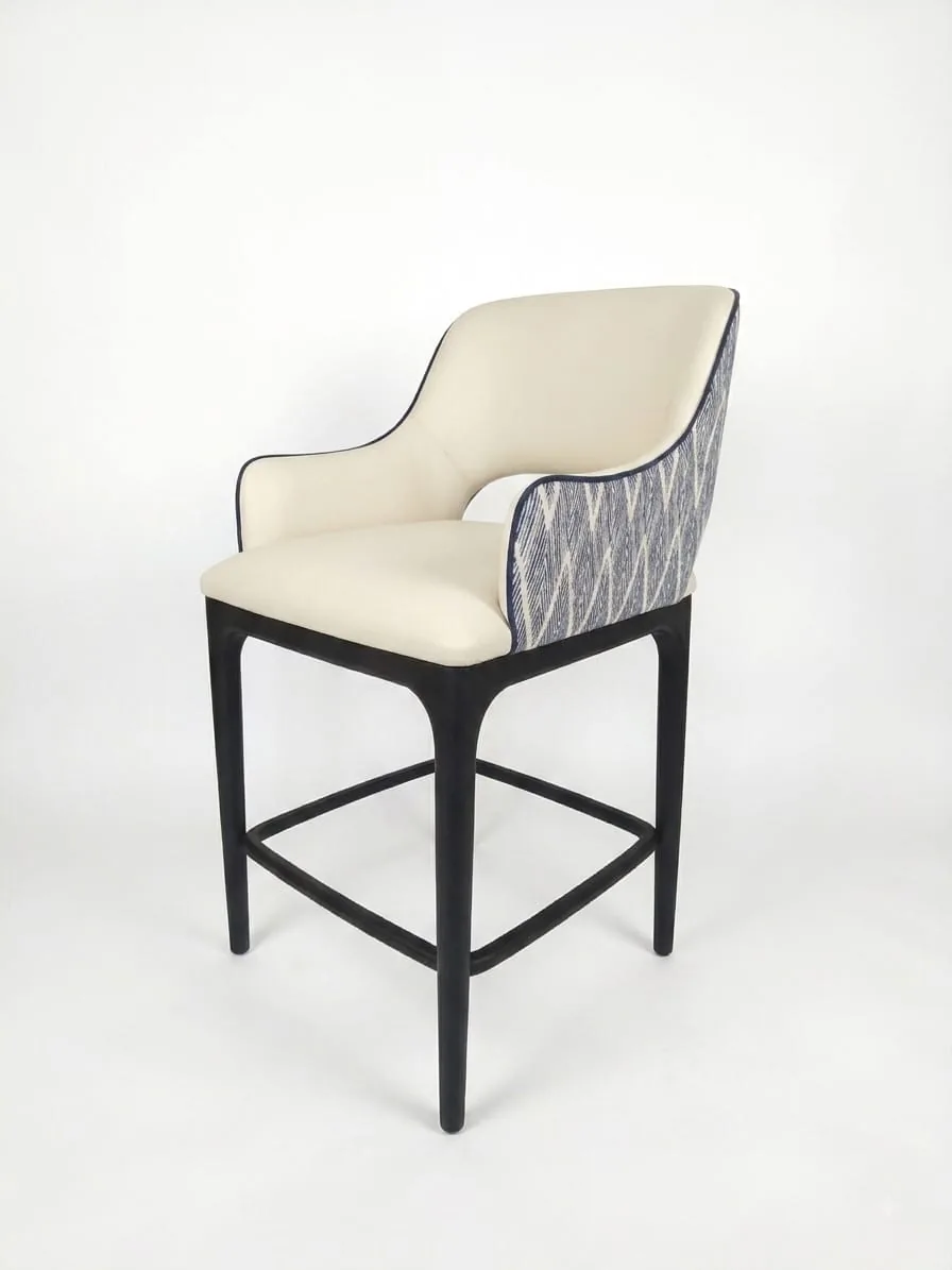 Upholstered bar stool with a cream seat and patterned grey back