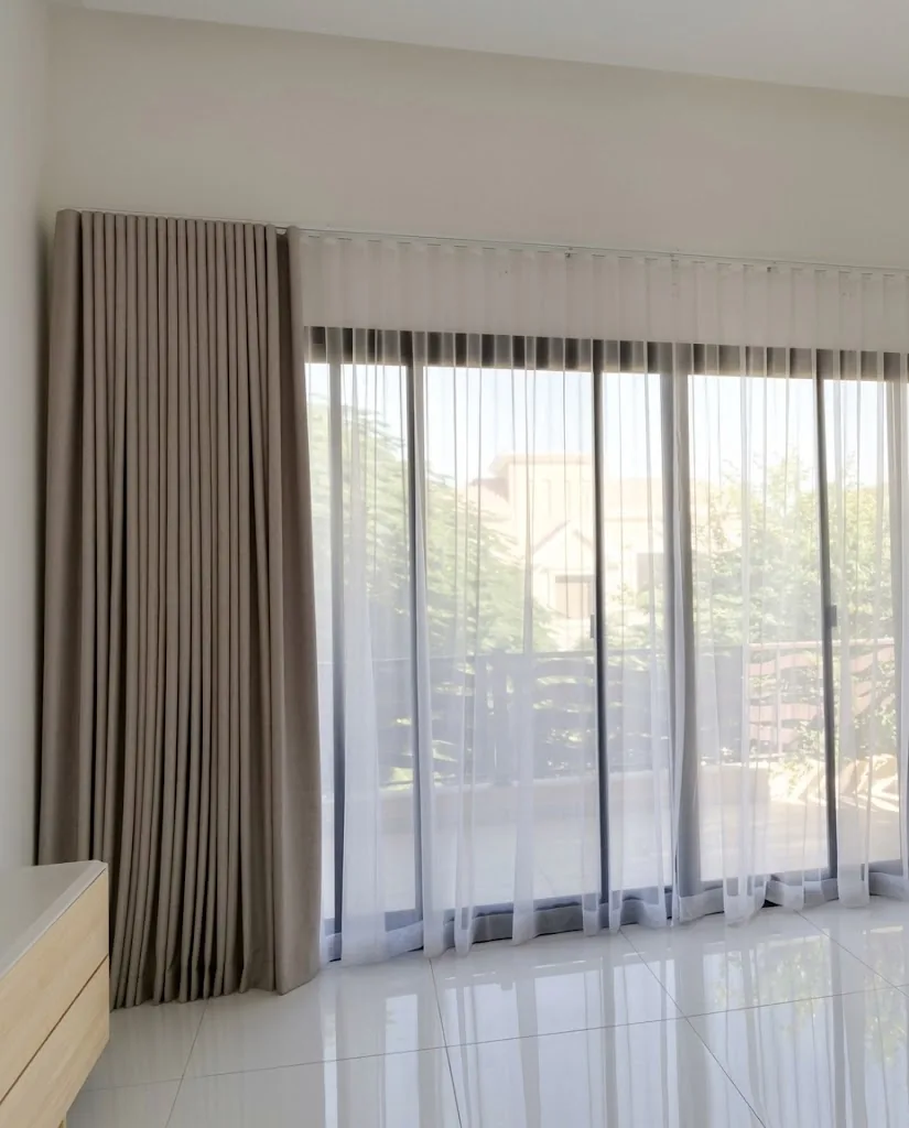 Grey wave curtains with sheers across glass sliding doors