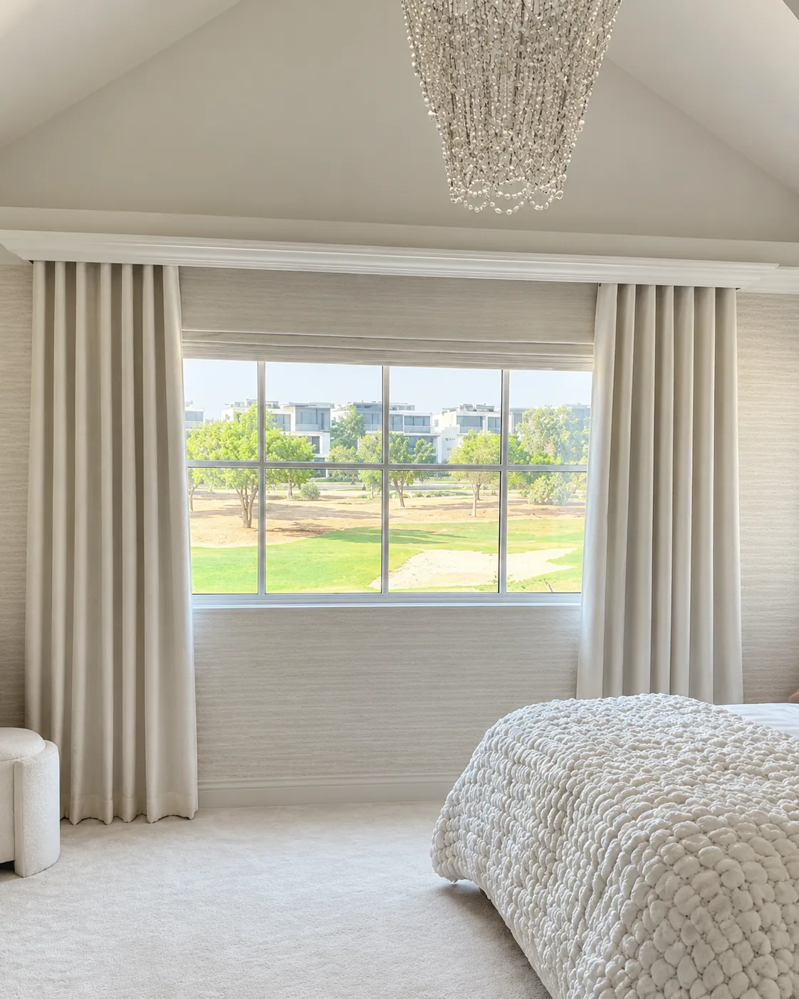 Cream wave curtains in a bedroom overlooking a golf course