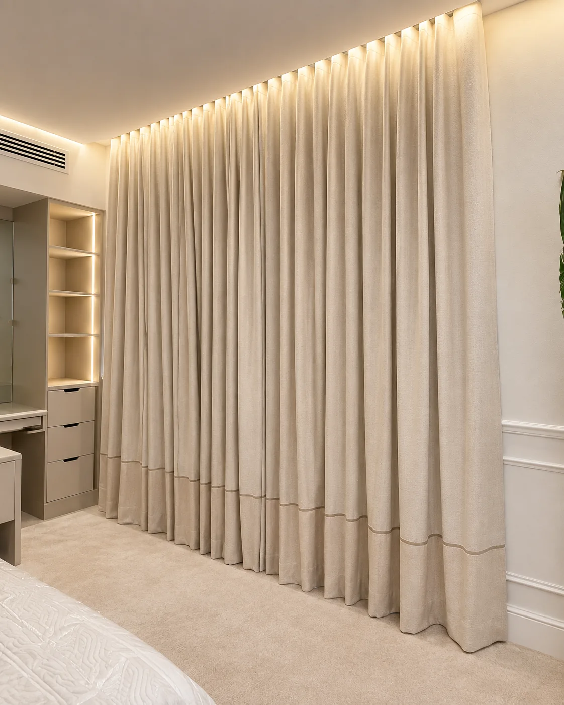 Cream wave curtains covering a full bedroom wall